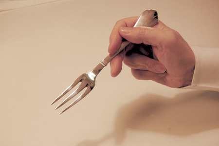 holding a fork when used by itself